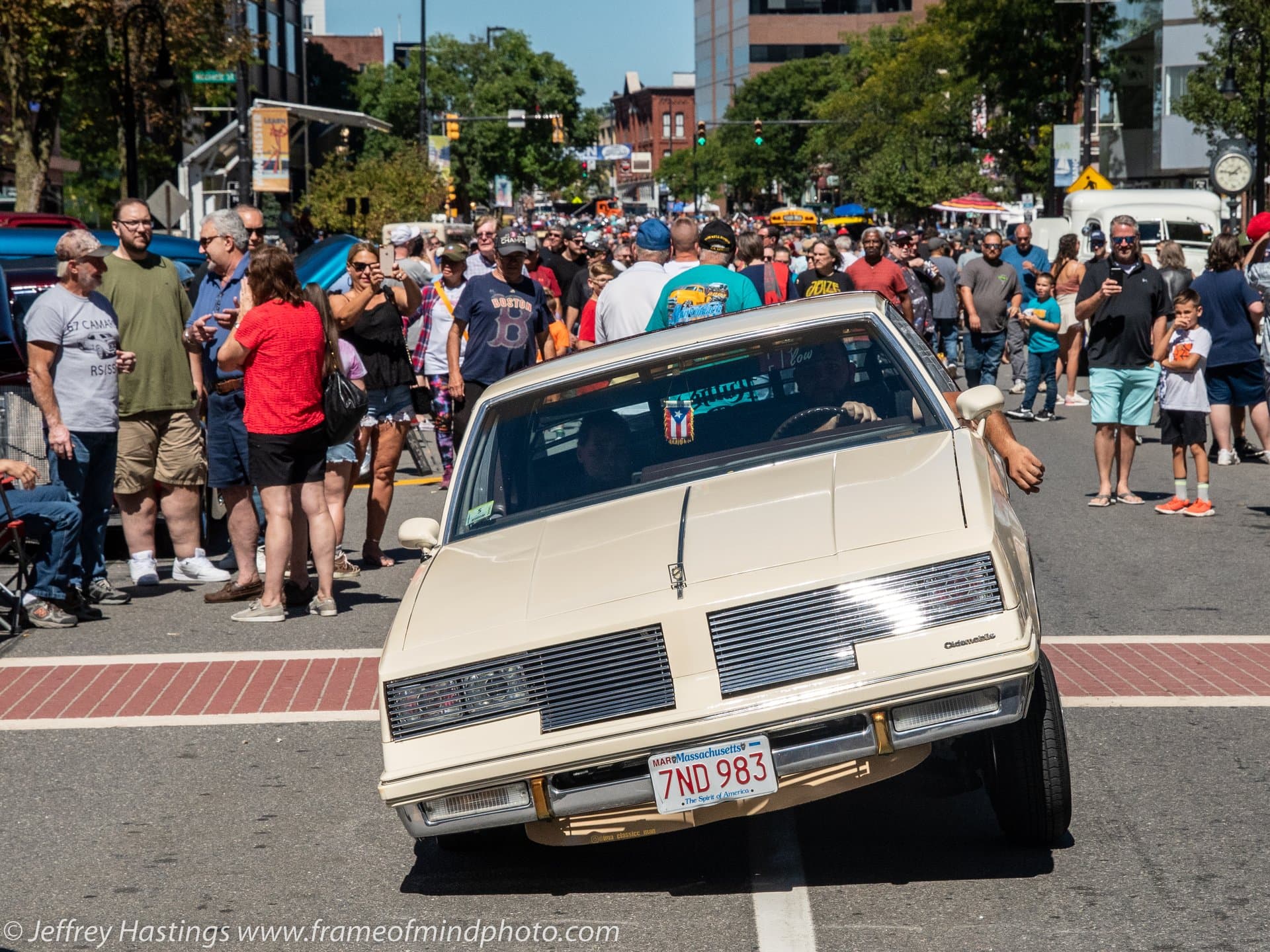 Classic car cruising through the crowd